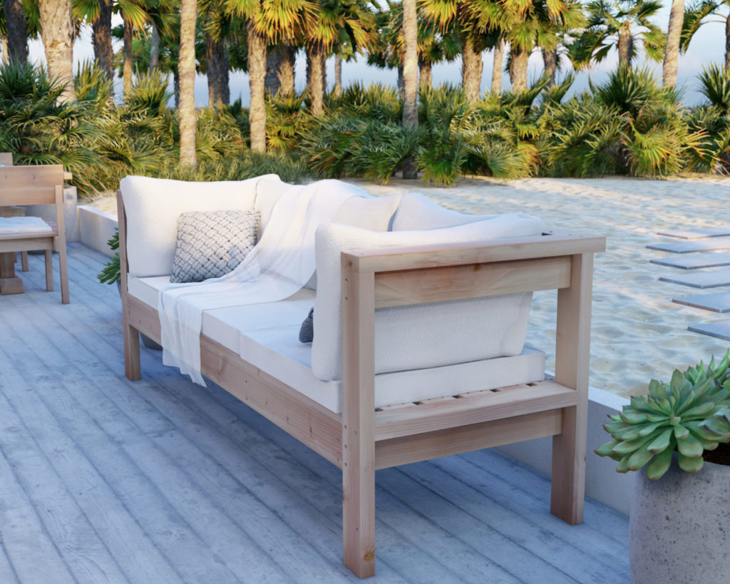 DIY 3-seater wooden sofa made from 2x4 lumber on a beach house patio, with base and backrest cushions for added comfort