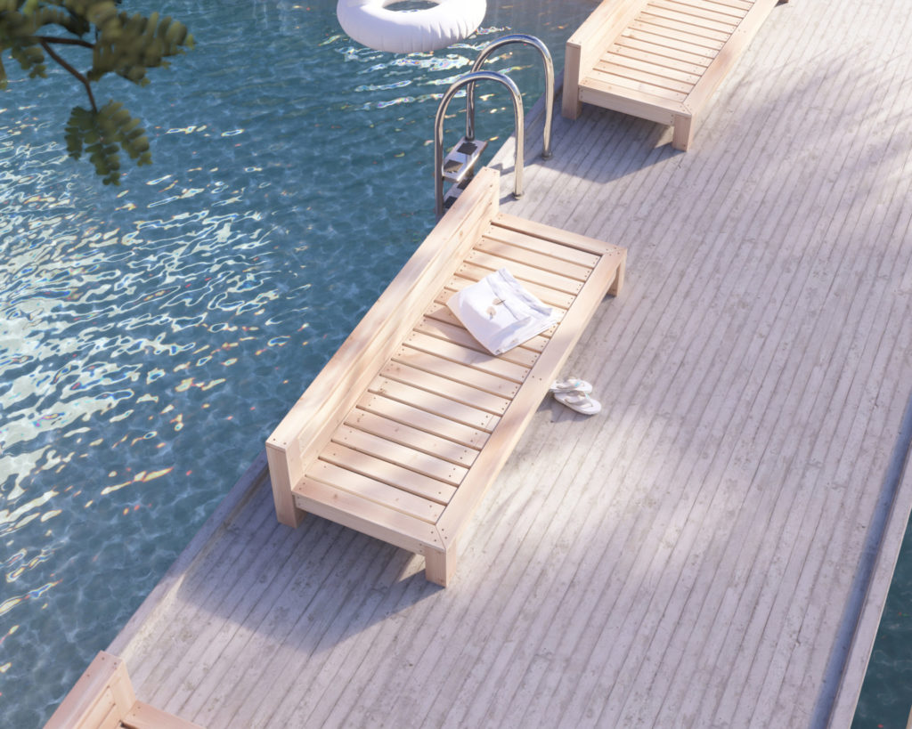 DIY wooden lounge bed by the pool in a tropical resort setting