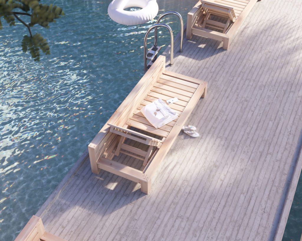 DIY wooden lounge bed by the pool in a tropical resort setting