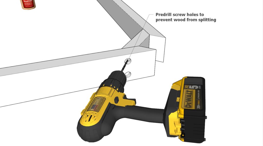 Using a drill bit to predrill the table top frame to prevent the wood from splitting