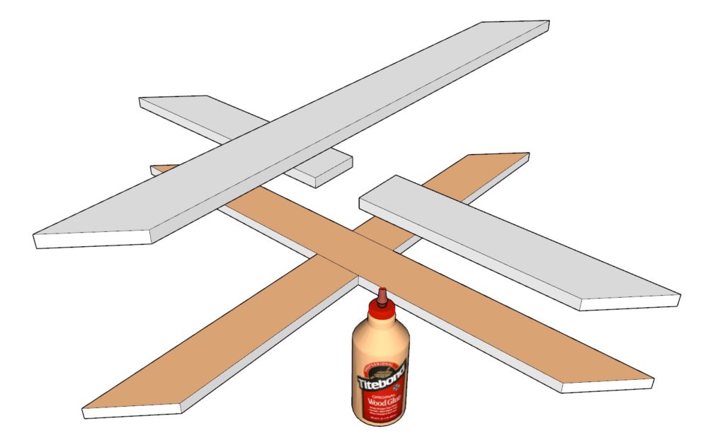 Adding glue to the crossbuck and attaching boards together using a nail gun