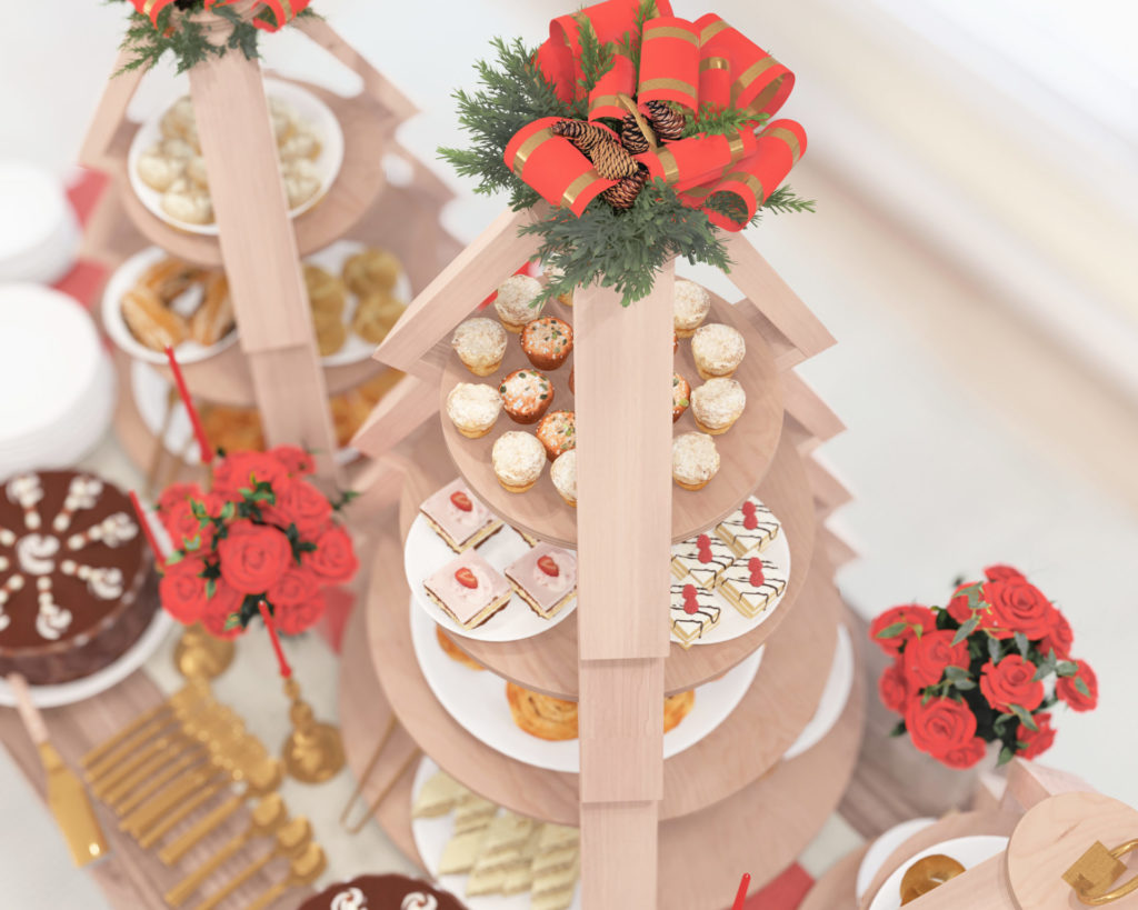 Christmas-themed tiered wooden stands displaying an assortment of festive treats, with a snowy window backdrop.
