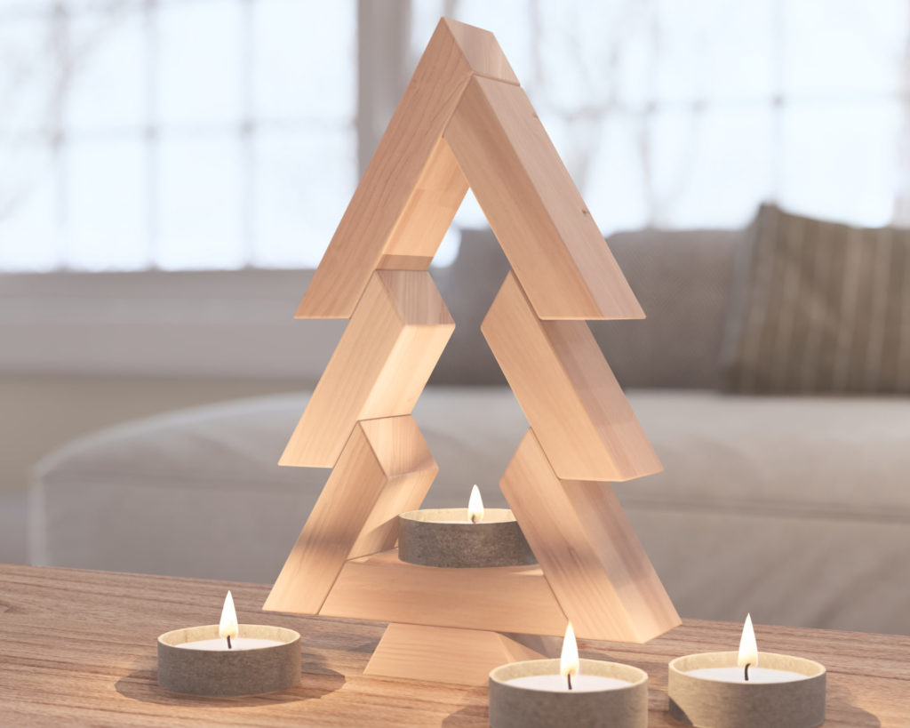 Handcrafted wooden Christmas tree decor on a tabletop with tealight candles illuminating its base.
