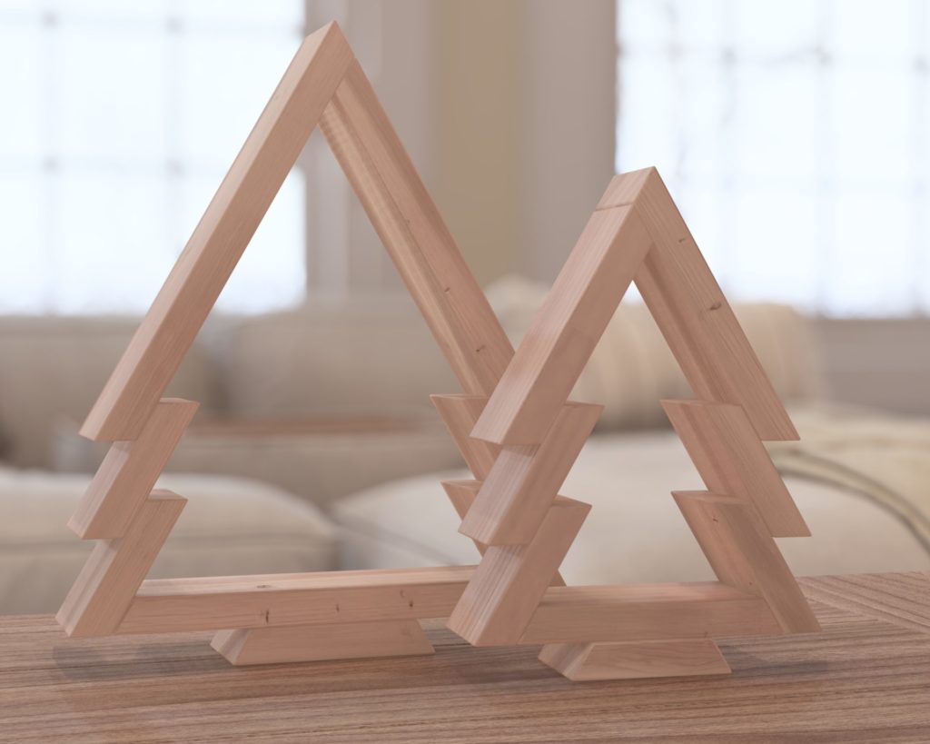 Nested wooden Christmas tree decorations with candle holders, made from 1x3 lumber and assembled with pin nails and glue, on a wooden floor and a mantelpiece.