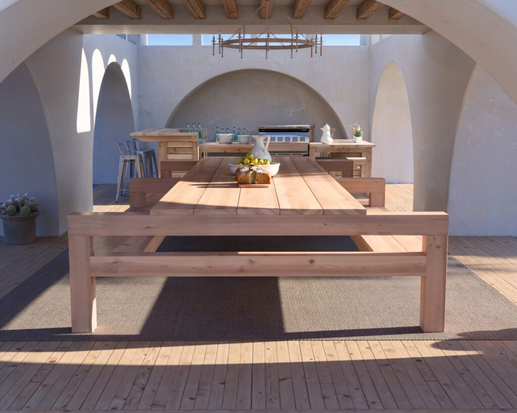 DIY wooden outdoor dining table with benches in a beautiful coastal setting, showcasing natural unfinished wood and robust construction.