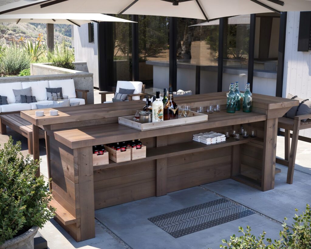 DIY L-shaped outdoor home bar made from common dimensional lumber, featuring a serving counter, adjustable shelf, and seating for four.