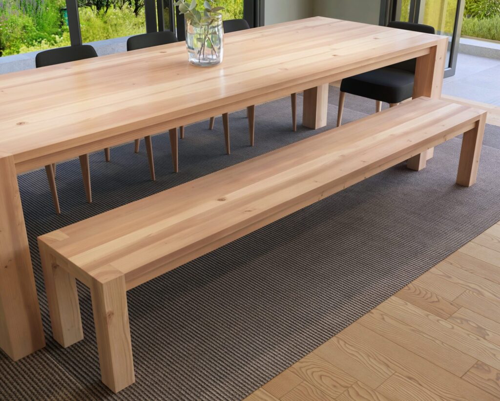 Close-up view of a wooden dining table and bench set highlighting the craftsmanship and natural wood finish.