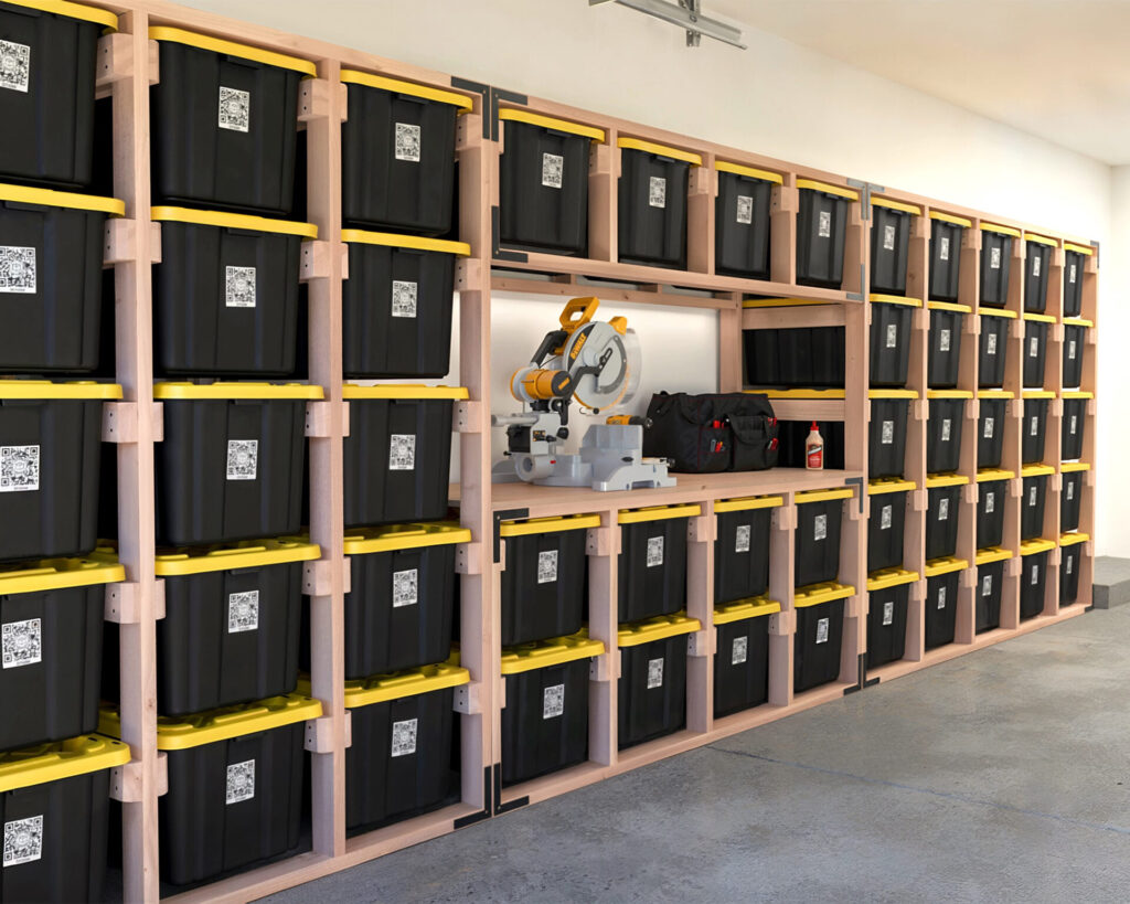 DIY 27-Gallon Tote Storage Rack in a garage, holding multiple black and yellow HDX storage totes, with a workbench integrated into the rack and a person scanning a tote using a QR code.