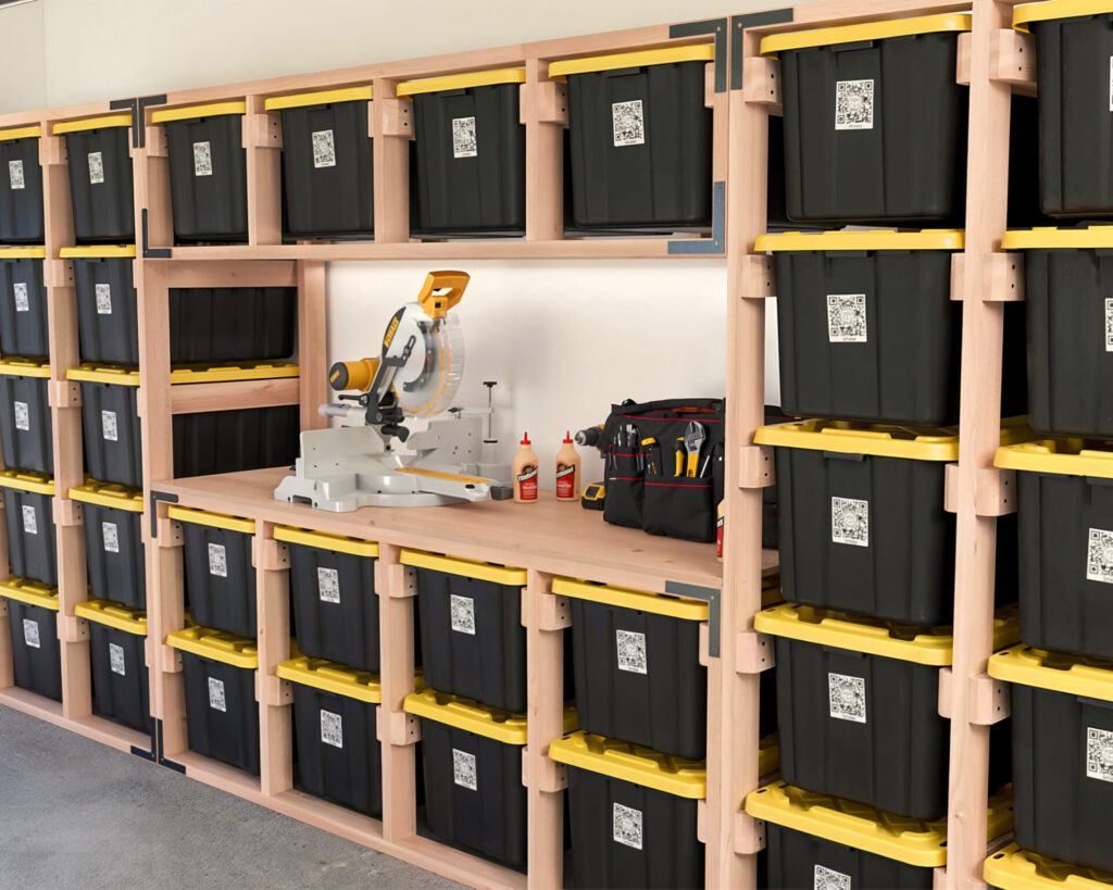 DIY 27-Gallon Tote Storage Rack in a garage, holding multiple black and yellow HDX storage totes, with a workbench integrated into the rack and a person scanning a tote using a QR code.