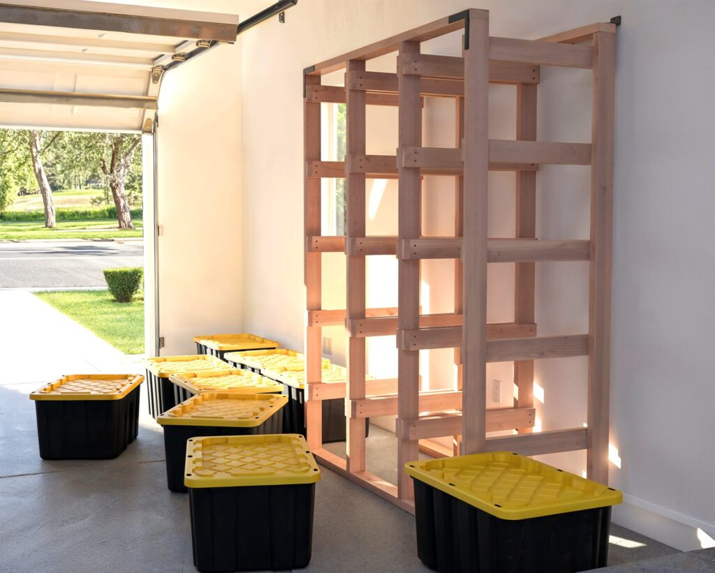 DIY 3x5 wooden storage rack for 27-gallon totes in a garage.