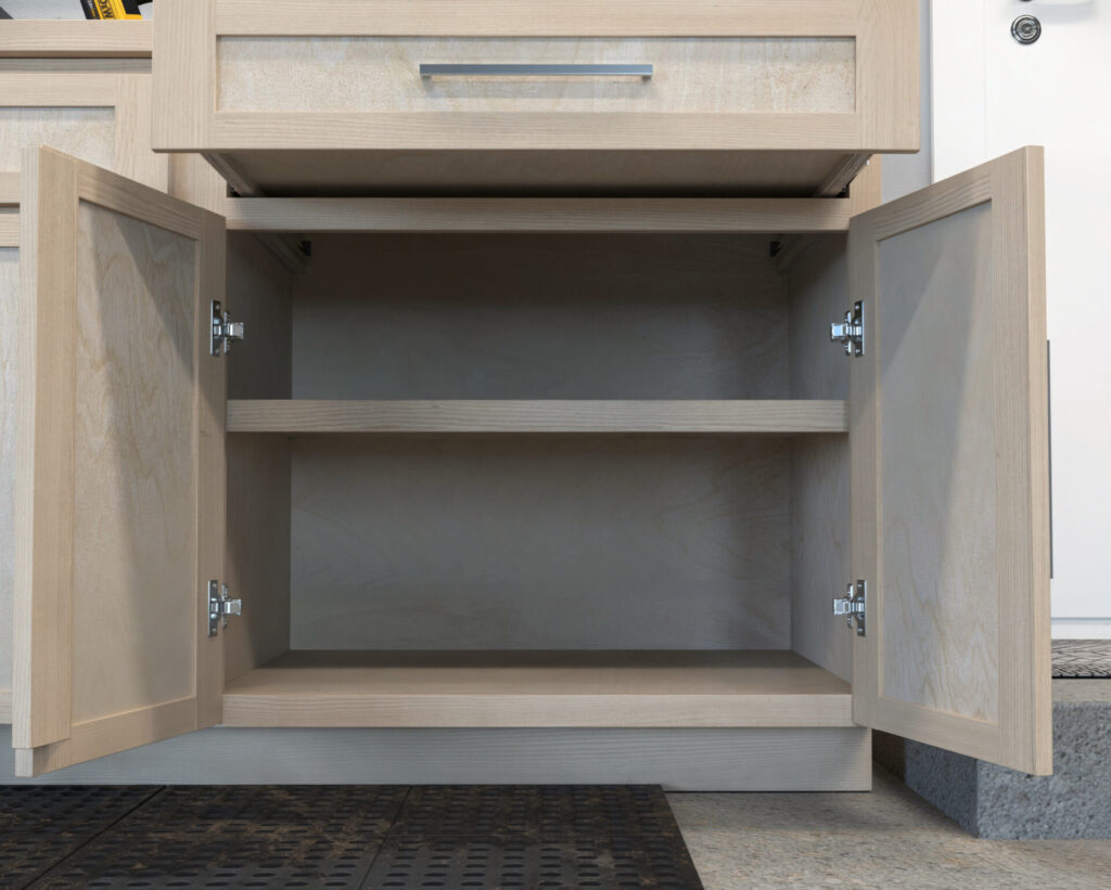 DIY garage wall and base cabinets designed for efficient storage, workspace organization, and tool accessibility.