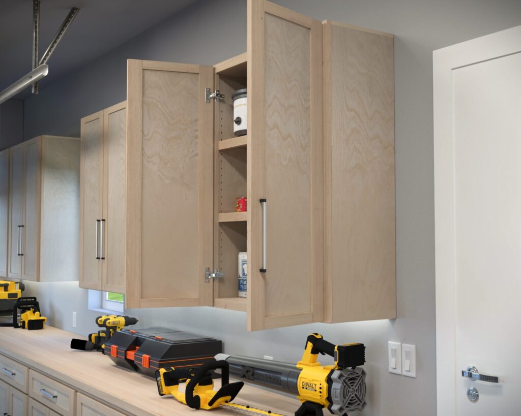 DIY garage wall and base cabinets designed for efficient storage, workspace organization, and tool accessibility.