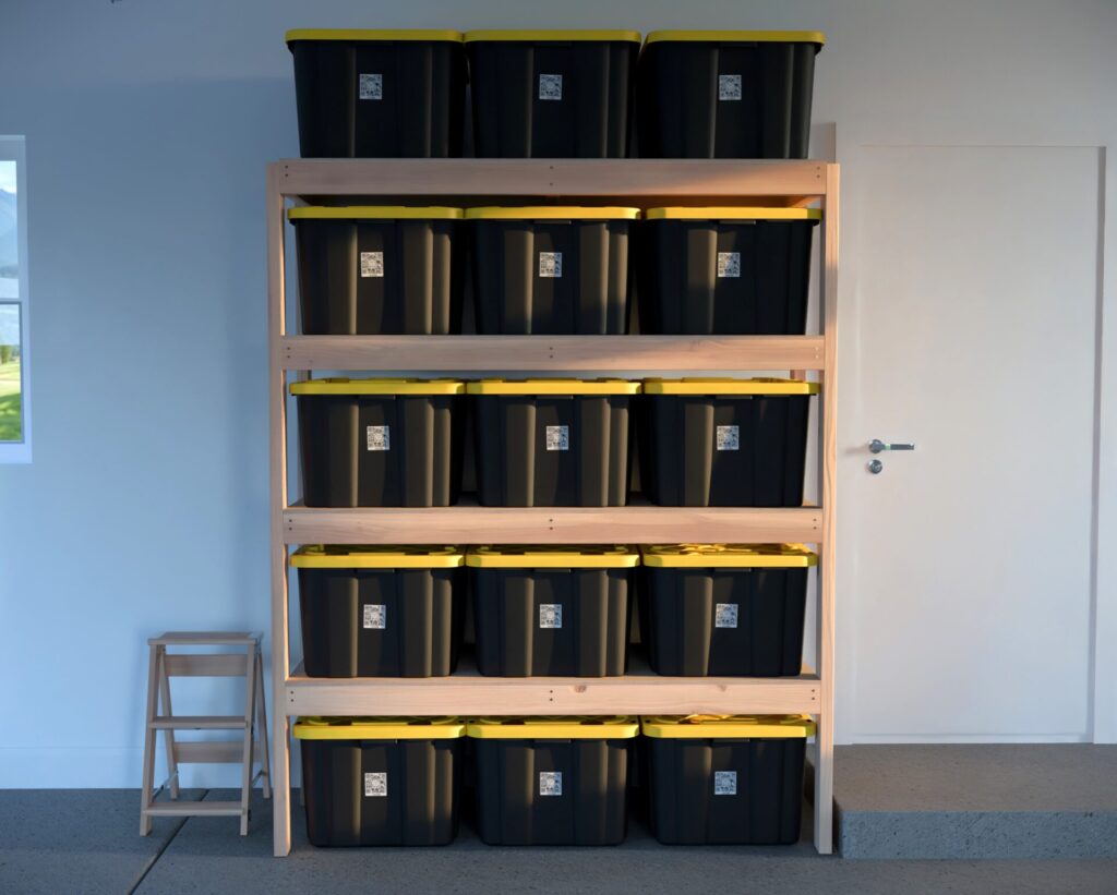 DIY garage shelving unit built with 2x4 lumber and plywood, designed to hold 27-gallon storage totes efficiently. The shelving features customizable configurations, making it a beginner-friendly and cost-effective storage solution for garages.