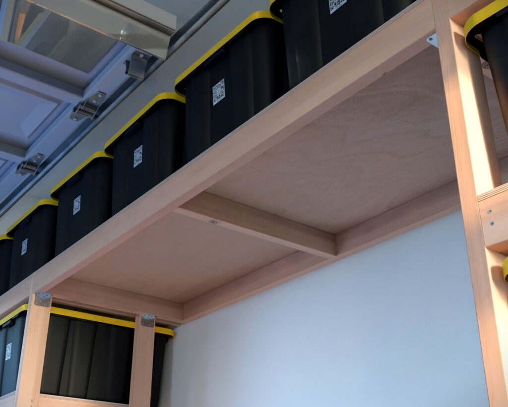 DIY garage shelving unit built with 2x4 lumber and plywood, designed to hold 27-gallon storage totes efficiently. The shelving features customizable configurations, making it a beginner-friendly and cost-effective storage solution for garages.