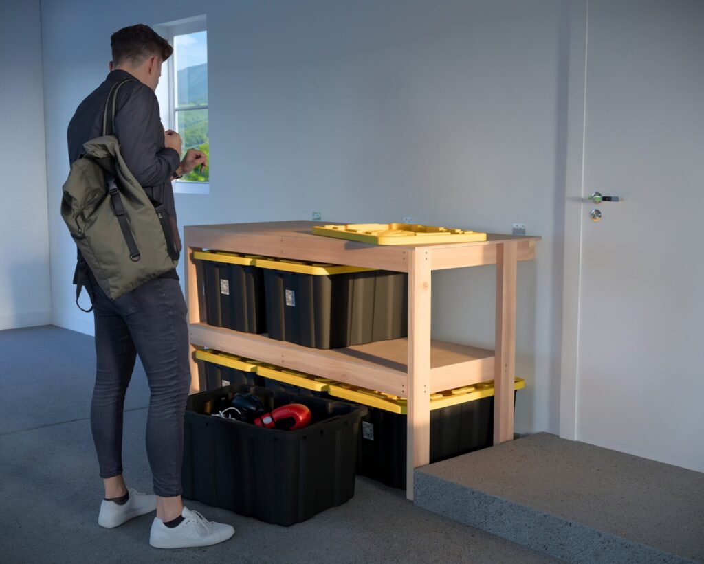 DIY garage shelving unit built with 2x4 lumber and plywood, designed to hold 27-gallon storage totes efficiently. The shelving features customizable configurations, making it a beginner-friendly and cost-effective storage solution for garages.