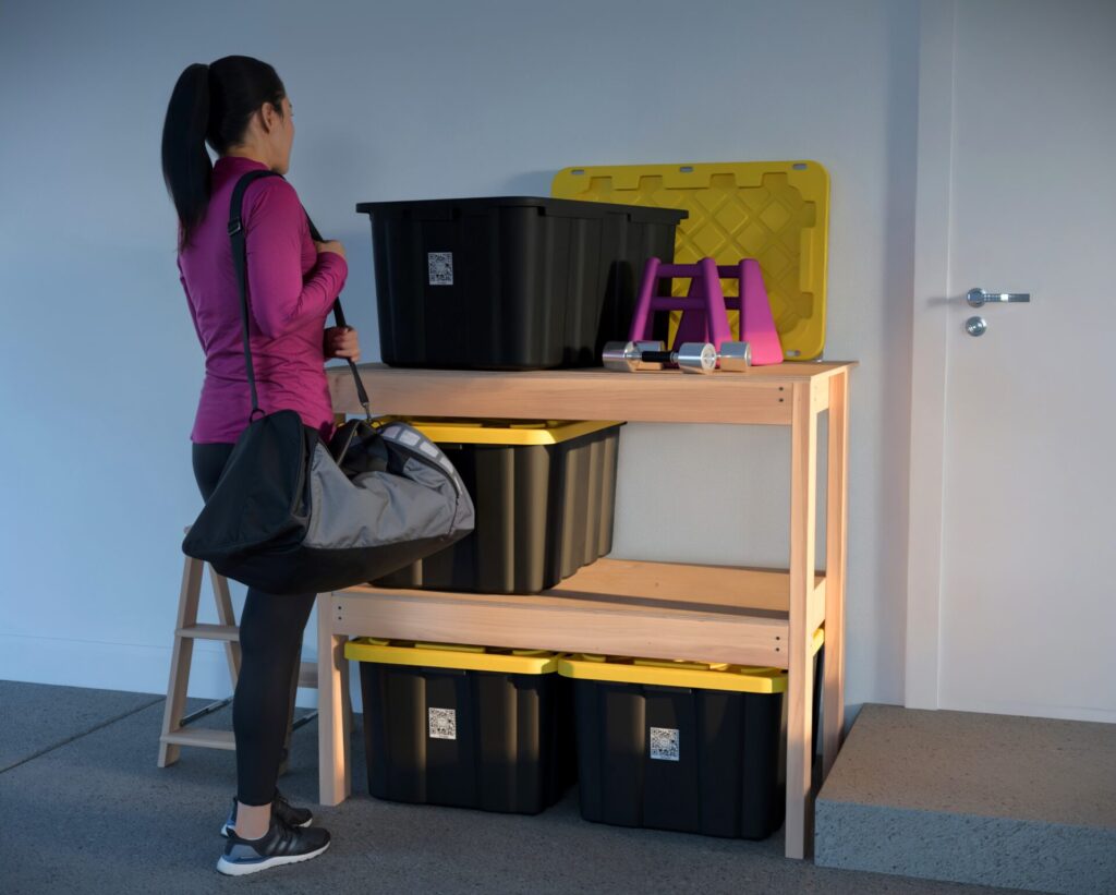 DIY garage shelving unit built with 2x4 lumber and plywood, designed to hold 27-gallon storage totes efficiently. The shelving features customizable configurations, making it a beginner-friendly and cost-effective storage solution for garages.