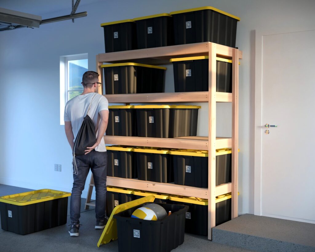 DIY garage shelving unit built with 2x4 lumber and plywood, designed to hold 27-gallon storage totes efficiently. The shelving features customizable configurations, making it a beginner-friendly and cost-effective storage solution for garages.